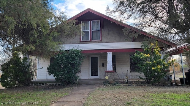 view of front facade with a front yard and a porch