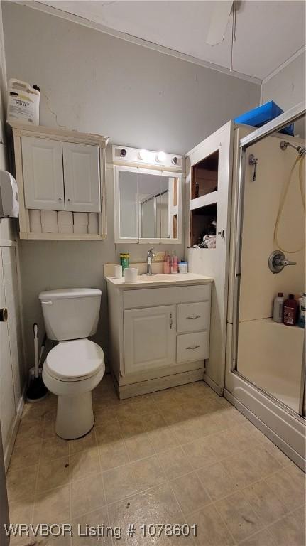 bathroom with walk in shower, vanity, and toilet