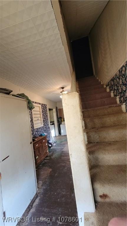 staircase with concrete flooring and ceiling fan
