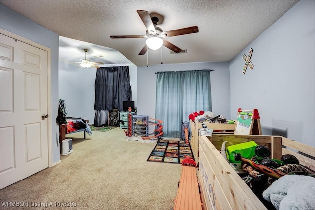 carpeted bedroom featuring ceiling fan and a textured ceiling