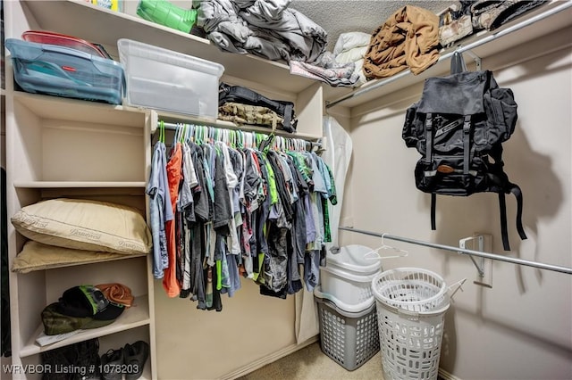 walk in closet with carpet flooring