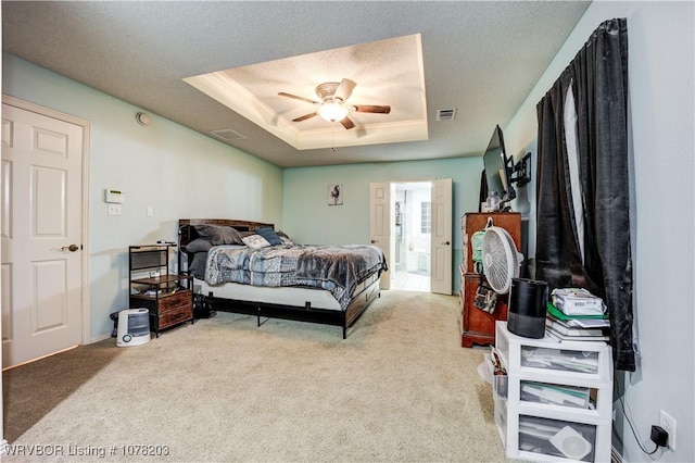 carpeted bedroom featuring a textured ceiling, a raised ceiling, and ceiling fan