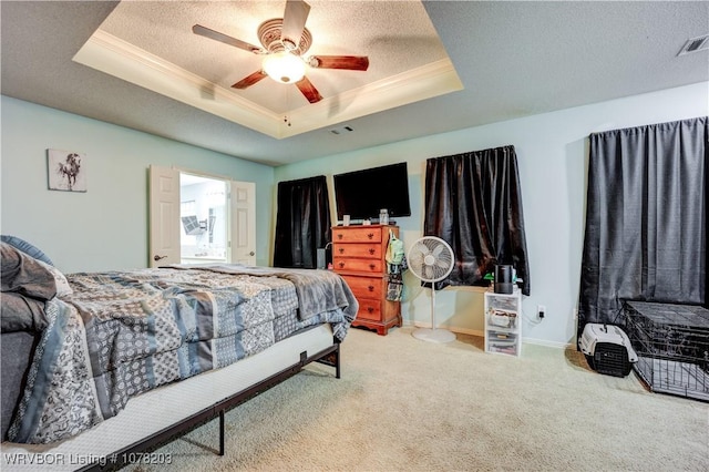 bedroom with a raised ceiling, crown molding, ceiling fan, a textured ceiling, and carpet floors