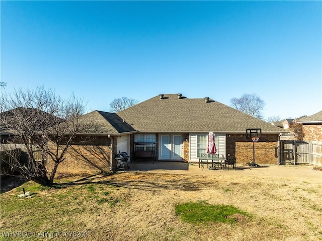 rear view of property with a yard and a patio