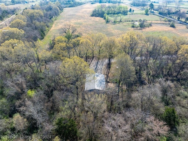 drone / aerial view featuring a wooded view
