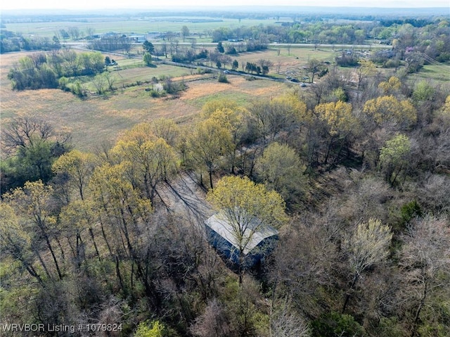 birds eye view of property featuring a forest view and a rural view