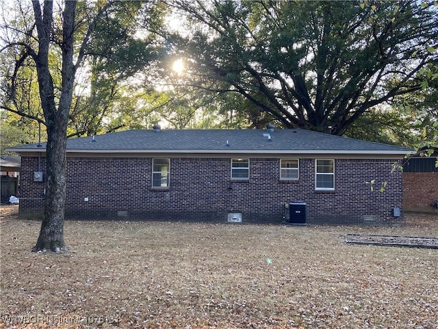 rear view of house featuring central AC unit