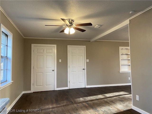 unfurnished bedroom with ceiling fan, dark hardwood / wood-style flooring, a textured ceiling, and crown molding