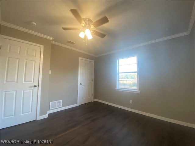 unfurnished bedroom with ceiling fan, dark hardwood / wood-style floors, and crown molding