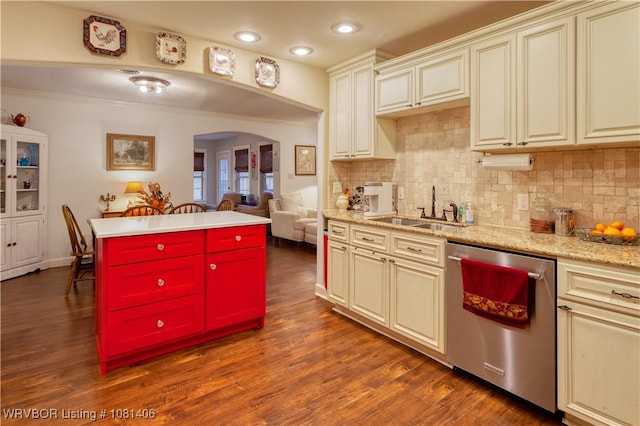 1326 56th Ter, Fort Smith, AR 72904 - kitchen with stainless steel dishwasher, a sink, arched walkways, tasteful backsplash, and dark wood-type flooring