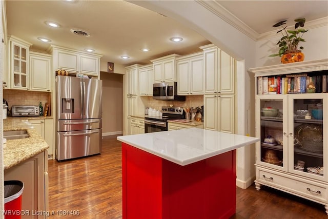 1326 56th Ter, Fort Smith, AR 72904 - kitchen featuring stainless steel appliances, crown molding, tasteful backsplash, dark wood-style flooring, and baseboards