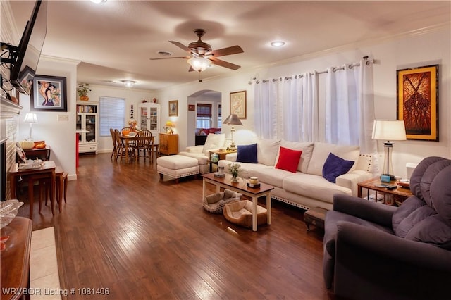 1326 56th Ter, Fort Smith, AR 72904 - living room featuring arched walkways, a ceiling fan, wood finished floors, crown molding, and a fireplace