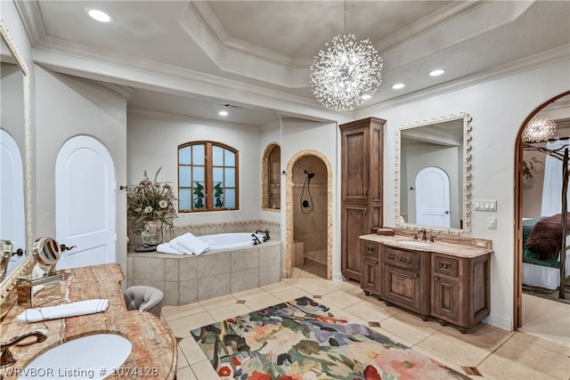 bathroom featuring ornamental molding, vanity, a tray ceiling, separate shower and tub, and an inviting chandelier
