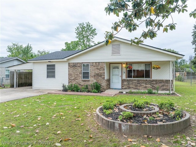 single story home featuring brick siding, concrete driveway, and a carport