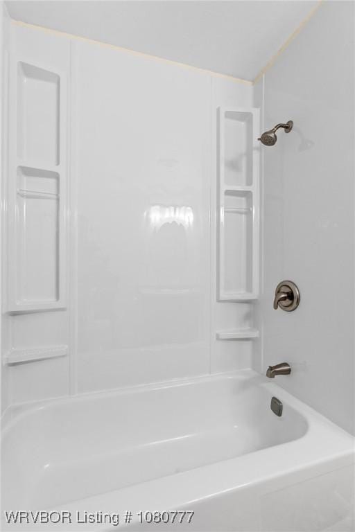 bathroom with bathing tub / shower combination