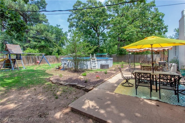 3811 Dallas St, Fort Smith, AR 72903 - fenced backyard with a playground, outdoor dining area, and a patio area