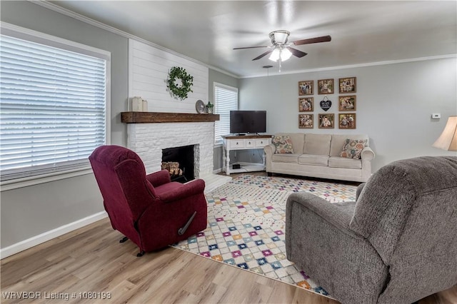 3811 Dallas St, Fort Smith, AR 72903 - living area with wood finished floors, a ceiling fan, crown molding, a brick fireplace, and baseboards