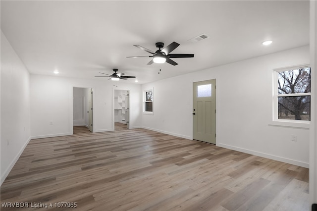 unfurnished living room with light hardwood / wood-style flooring and ceiling fan