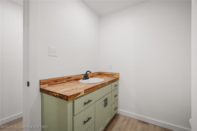 bathroom with vanity and wood-type flooring