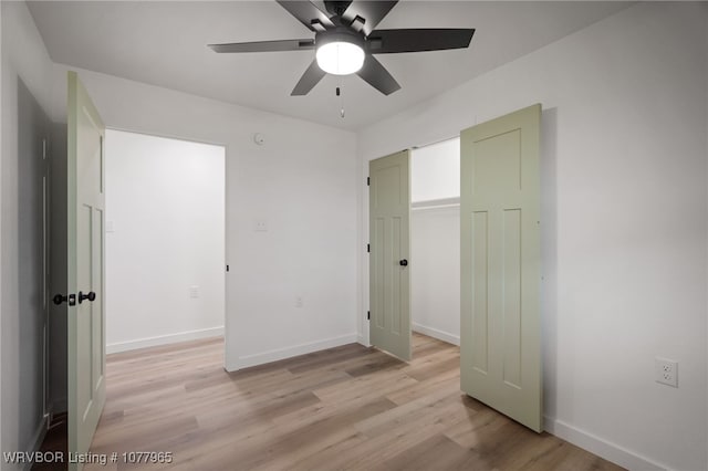 unfurnished bedroom featuring ceiling fan, a closet, and light hardwood / wood-style flooring