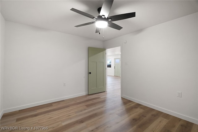 spare room featuring hardwood / wood-style floors and ceiling fan