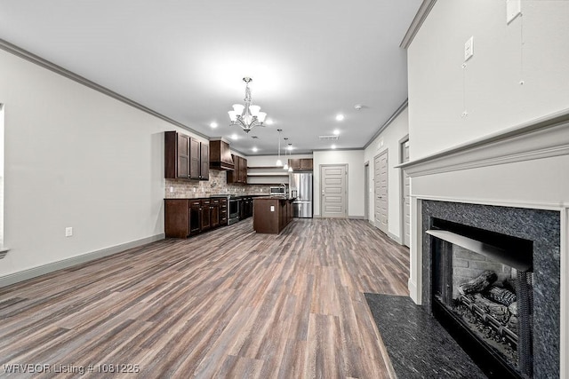 9205 R A Young Jr Dr, Fort Smith, AR 72916 - kitchen with stainless steel appliances, wall chimney exhaust hood, ornamental molding, a chandelier, and a high end fireplace