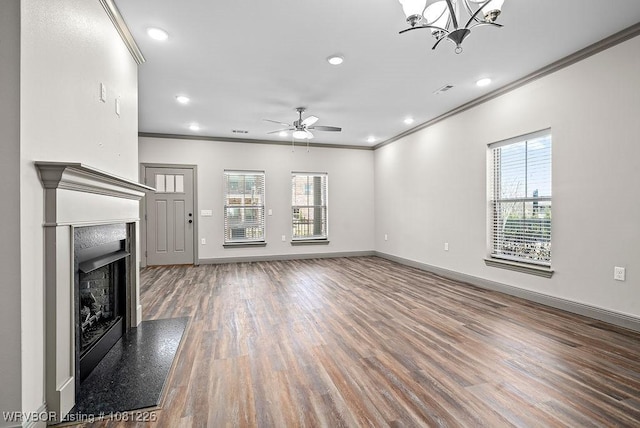 9205 R A Young Jr Dr, Fort Smith, AR 72916 - unfurnished living room with crown molding, healthy amount of natural light, wood finished floors, ceiling fan, and baseboards