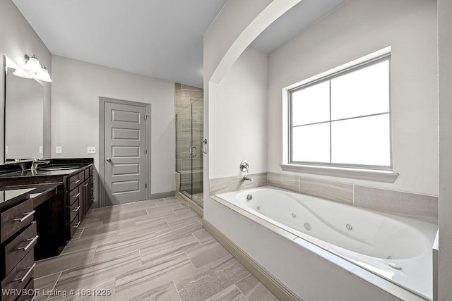 9205 R A Young Jr Dr, Fort Smith, AR 72916 - bathroom featuring double vanity, a shower stall, and a whirlpool tub