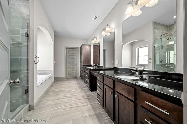 9205 R A Young Jr Dr, Fort Smith, AR 72916 - bathroom featuring a shower stall, vanity, a bath, and baseboards