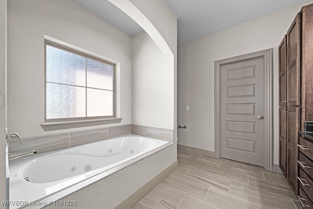 9205 R A Young Jr Dr, Fort Smith, AR 72916 - bathroom featuring a tub with jets and baseboards