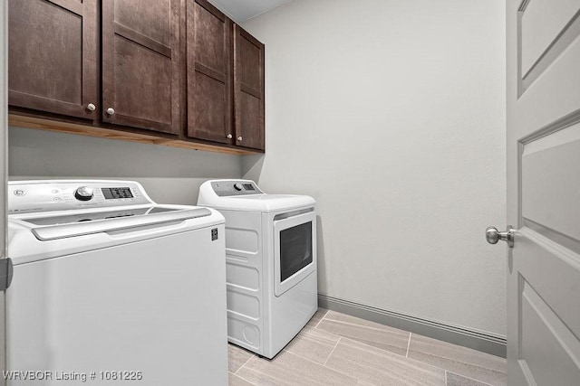 9205 R A Young Jr Dr, Fort Smith, AR 72916 - washroom featuring washing machine and clothes dryer, cabinet space, and baseboards