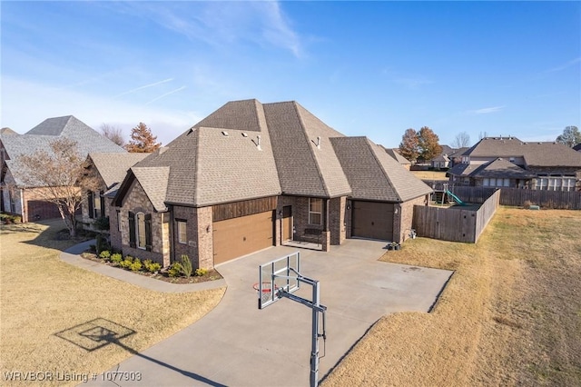 view of front of property with a garage and a front lawn