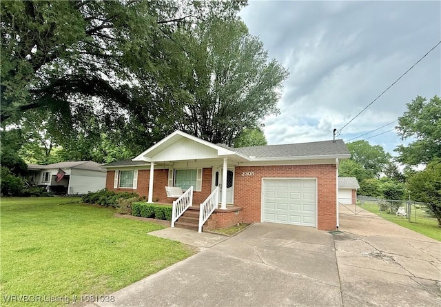 ranch-style home with a garage, driveway, brick siding, covered porch, and roof with shingles