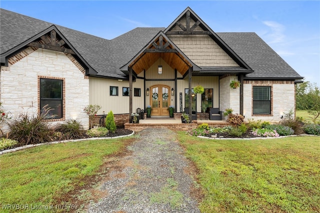 view of front of home featuring a front yard and french doors