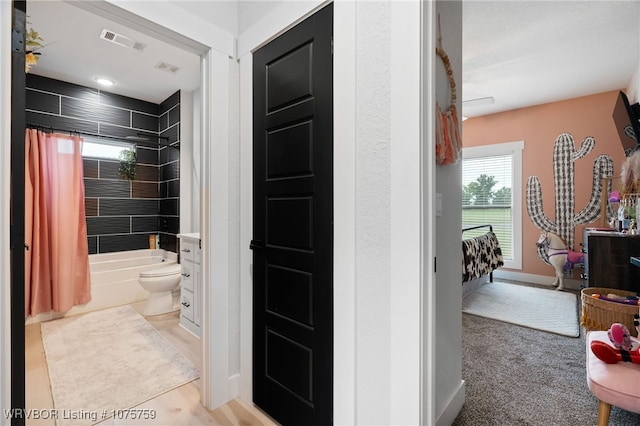 full bathroom with shower / bath combination with curtain, toilet, and vanity