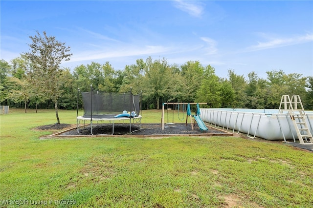 exterior space featuring a trampoline and a yard