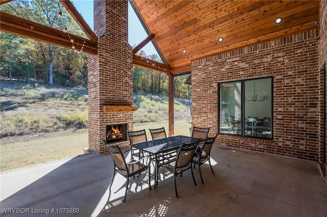 view of patio / terrace with an outdoor brick fireplace