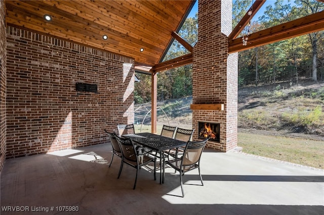 view of patio with an outdoor brick fireplace