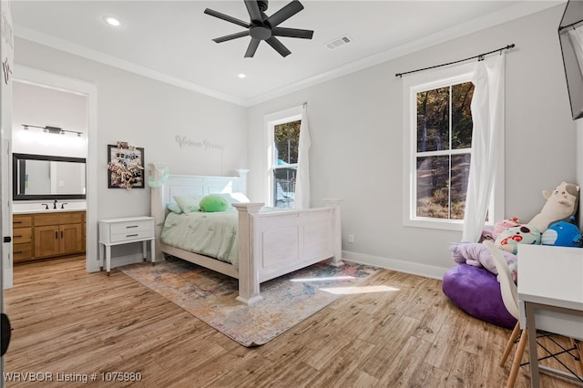 bedroom featuring ceiling fan, crown molding, ensuite bathroom, and light hardwood / wood-style floors