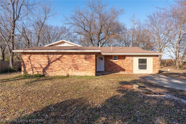 rear view of property with a lawn