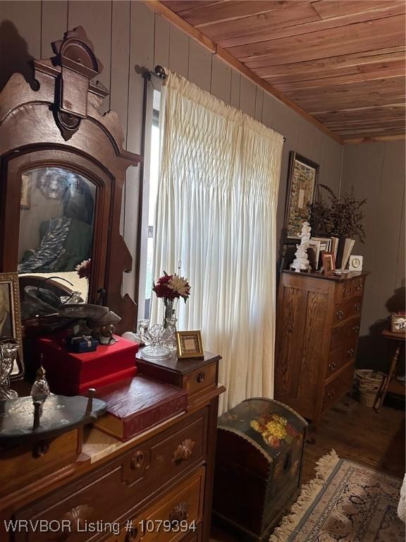 sitting room featuring wood finished floors, wood ceiling, and wood walls