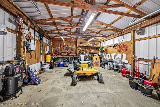 garage featuring a workshop area and metal wall