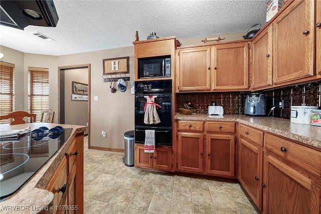 kitchen with tasteful backsplash, visible vents, brown cabinets, black appliances, and a warming drawer