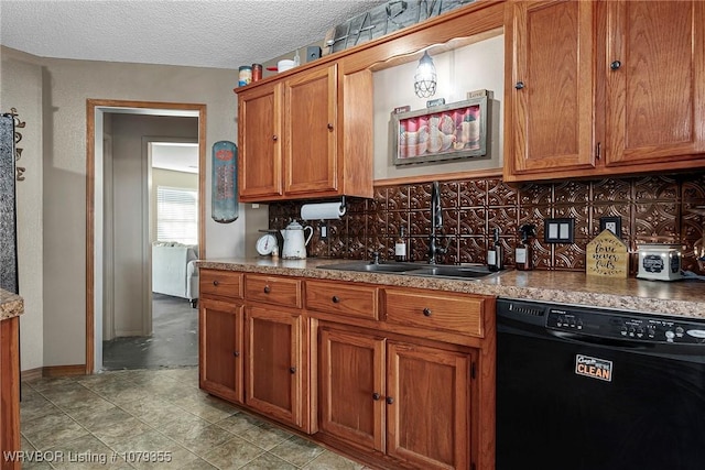 kitchen featuring tasteful backsplash, brown cabinets, dishwasher, and a sink