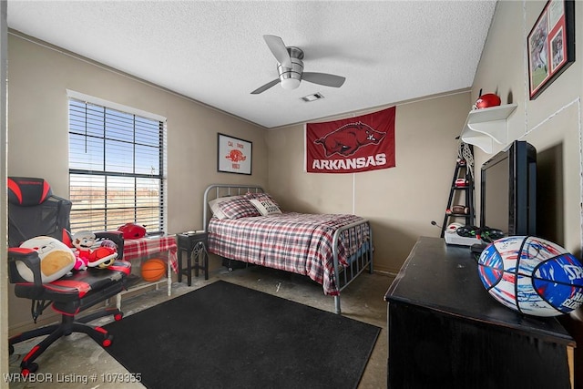 bedroom with ceiling fan, visible vents, concrete flooring, and a textured ceiling