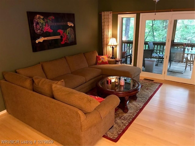living room featuring light wood-type flooring and visible vents