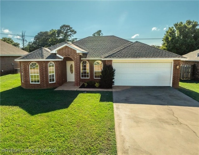 view of front of property with brick siding, concrete driveway, a front yard, and an attached garage