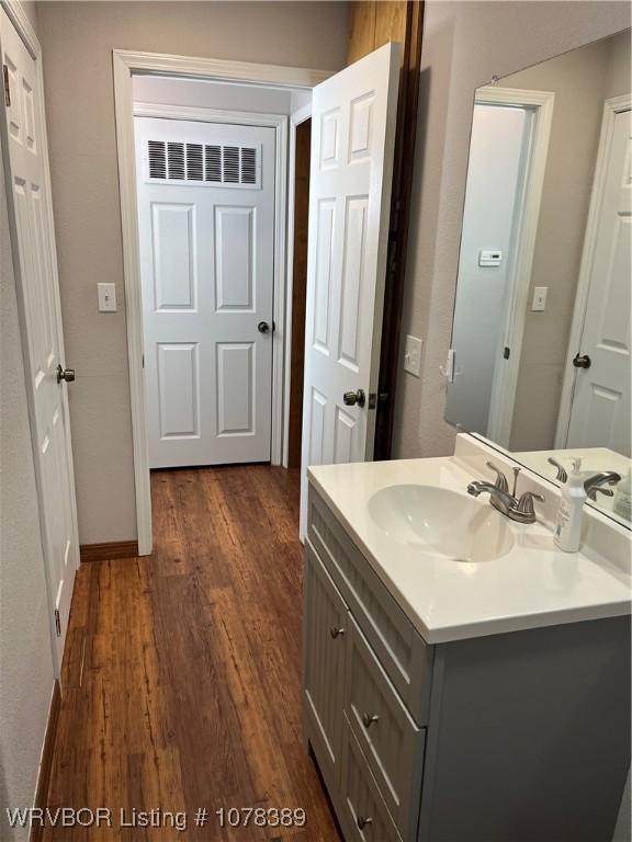 bathroom featuring hardwood / wood-style floors and vanity