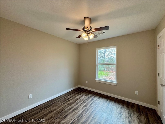 unfurnished room with dark hardwood / wood-style floors and ceiling fan