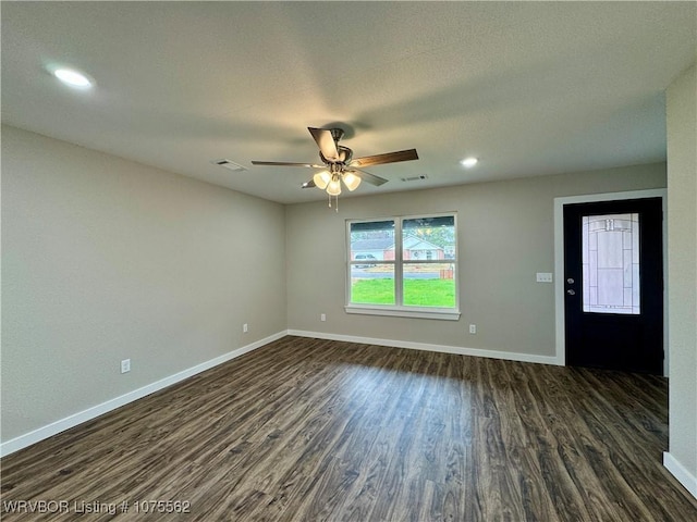 empty room featuring ceiling fan and dark wood-type flooring